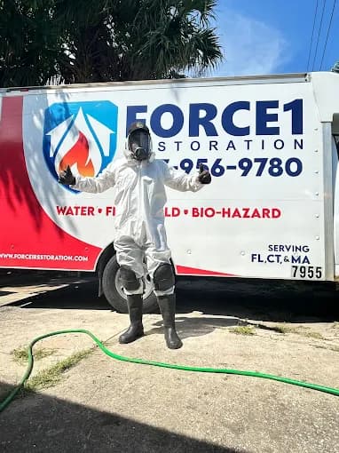 Force1 Restoration IICRC-certified technician in full PPE including respirator and hazmat suit, ready for mold remediation